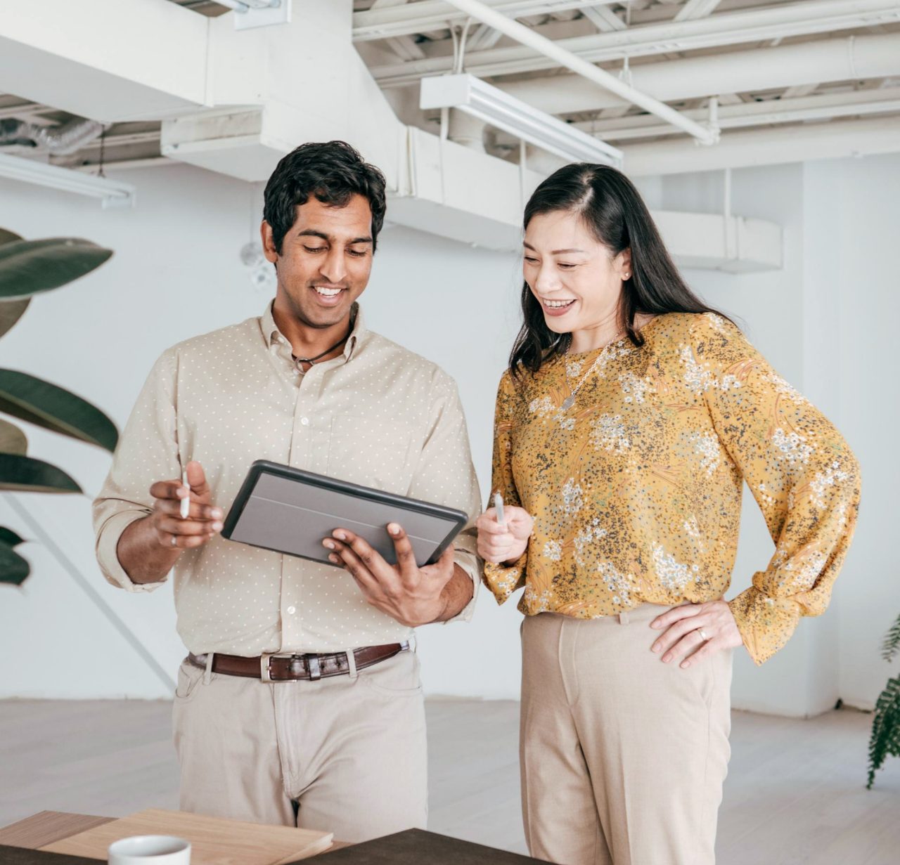 canva-diverse-colleagues-office-standing-discussing