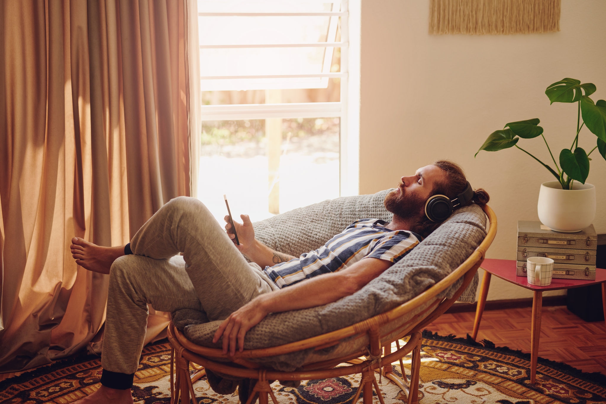 Man relaxing on chair with headphones