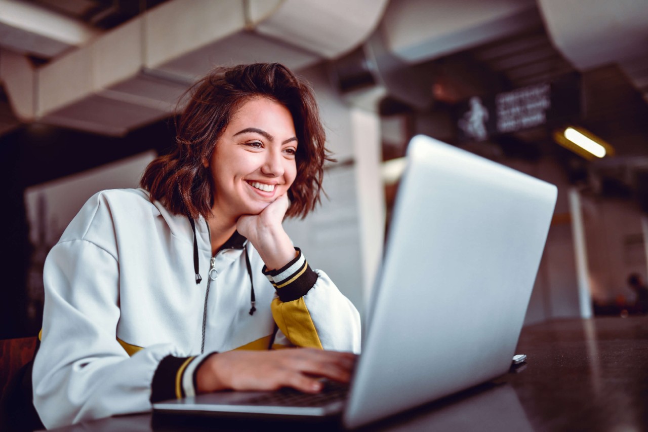 Young female on her laptop smiling 