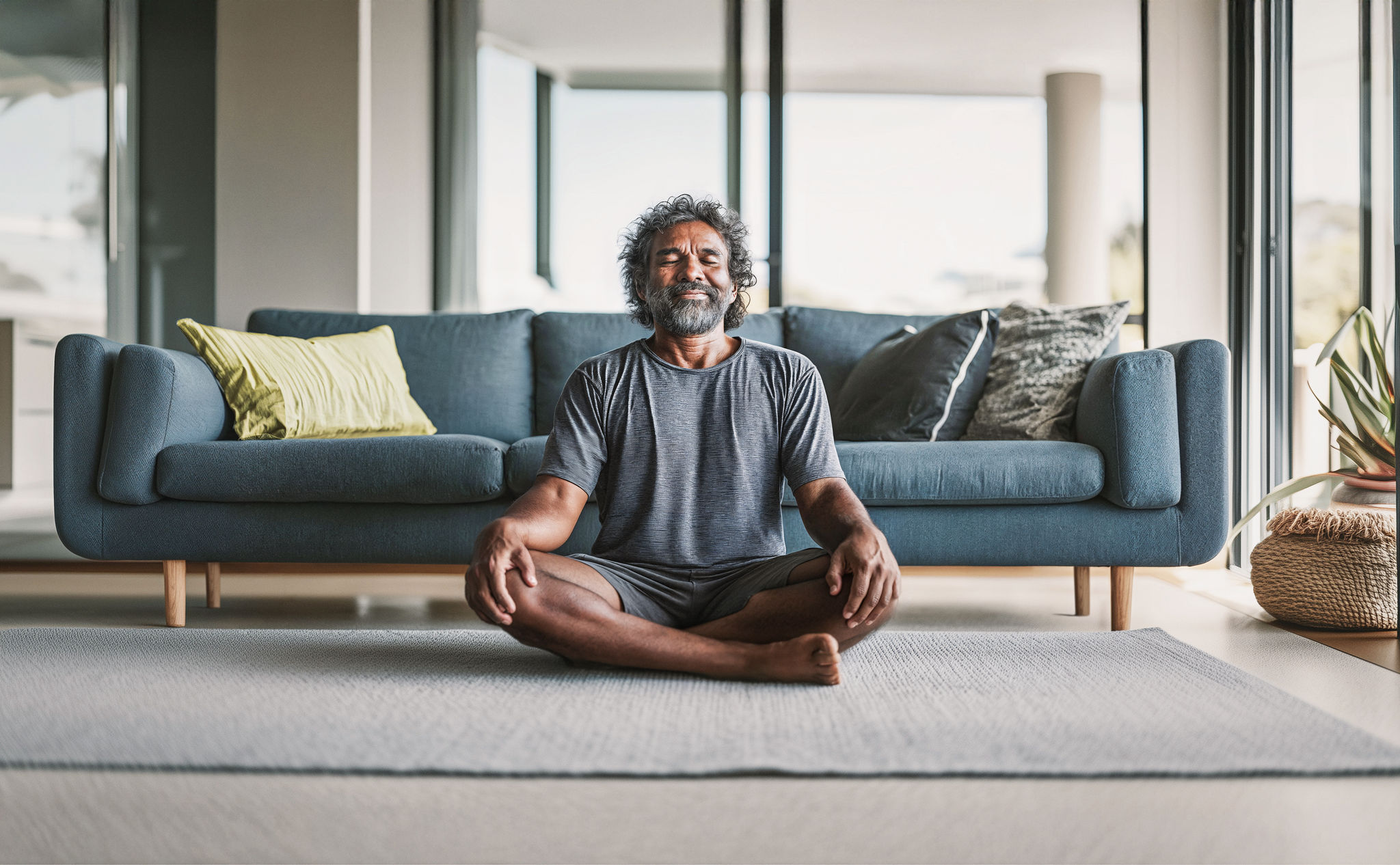 Man in his living room meditating 