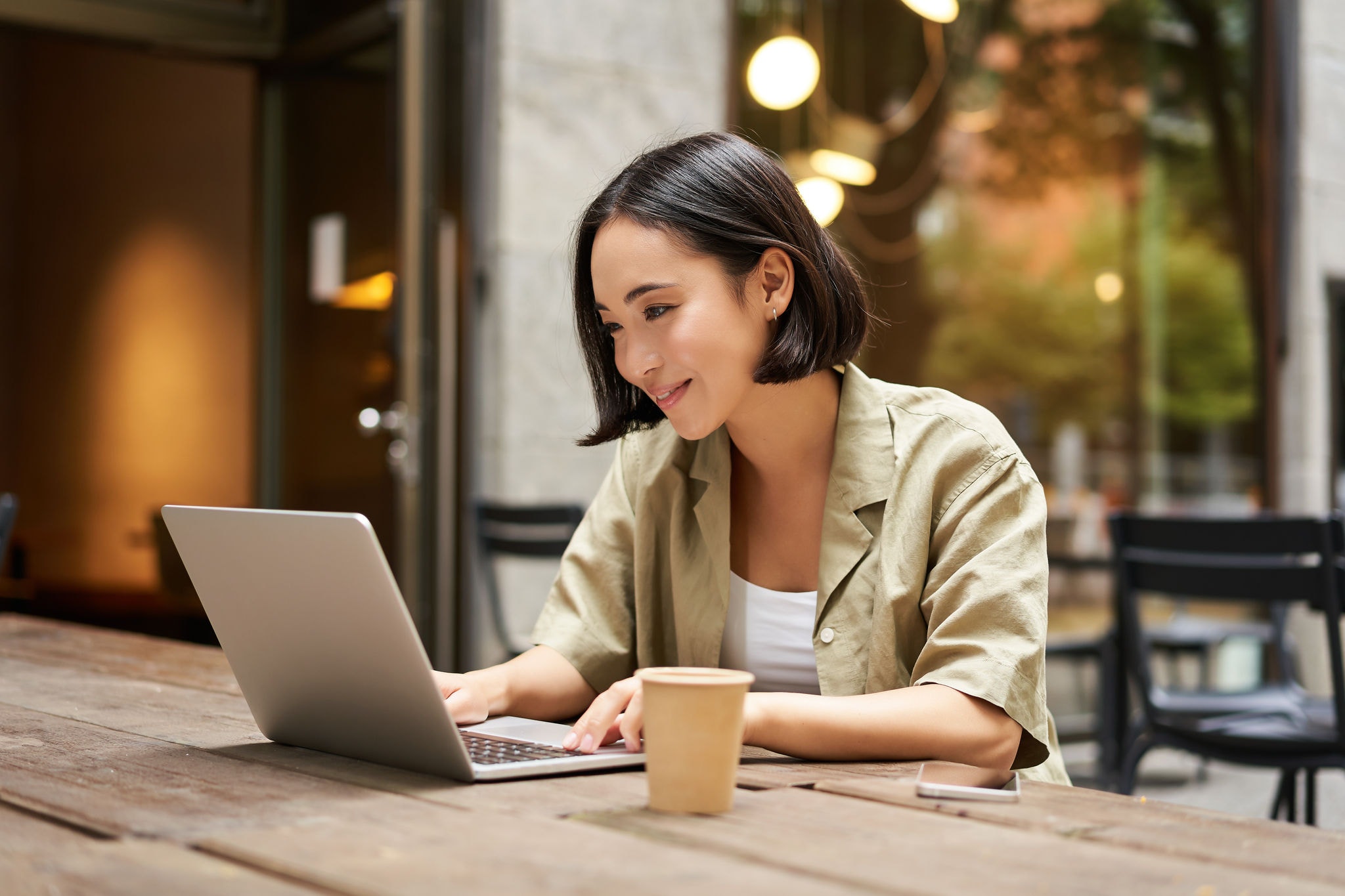 Woman working remotely from a cafe
