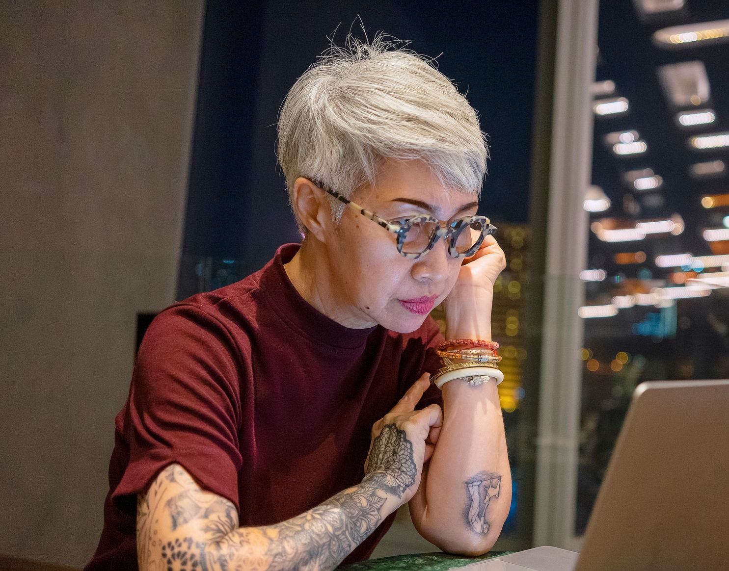 Woman working on laptop at night