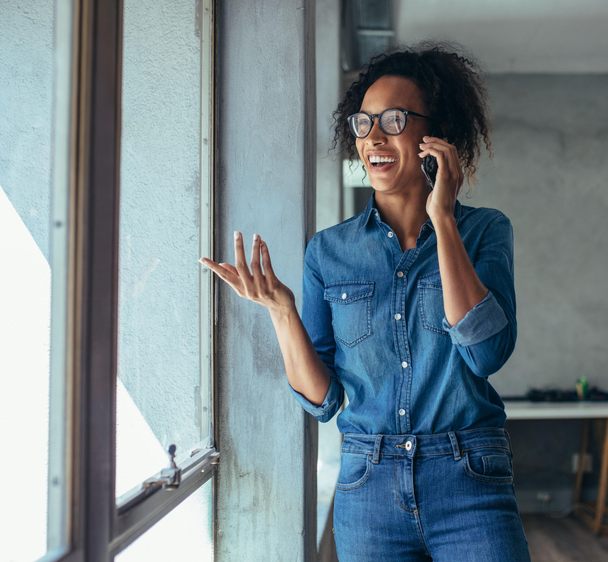 canva-woman-office-window-talking-phone