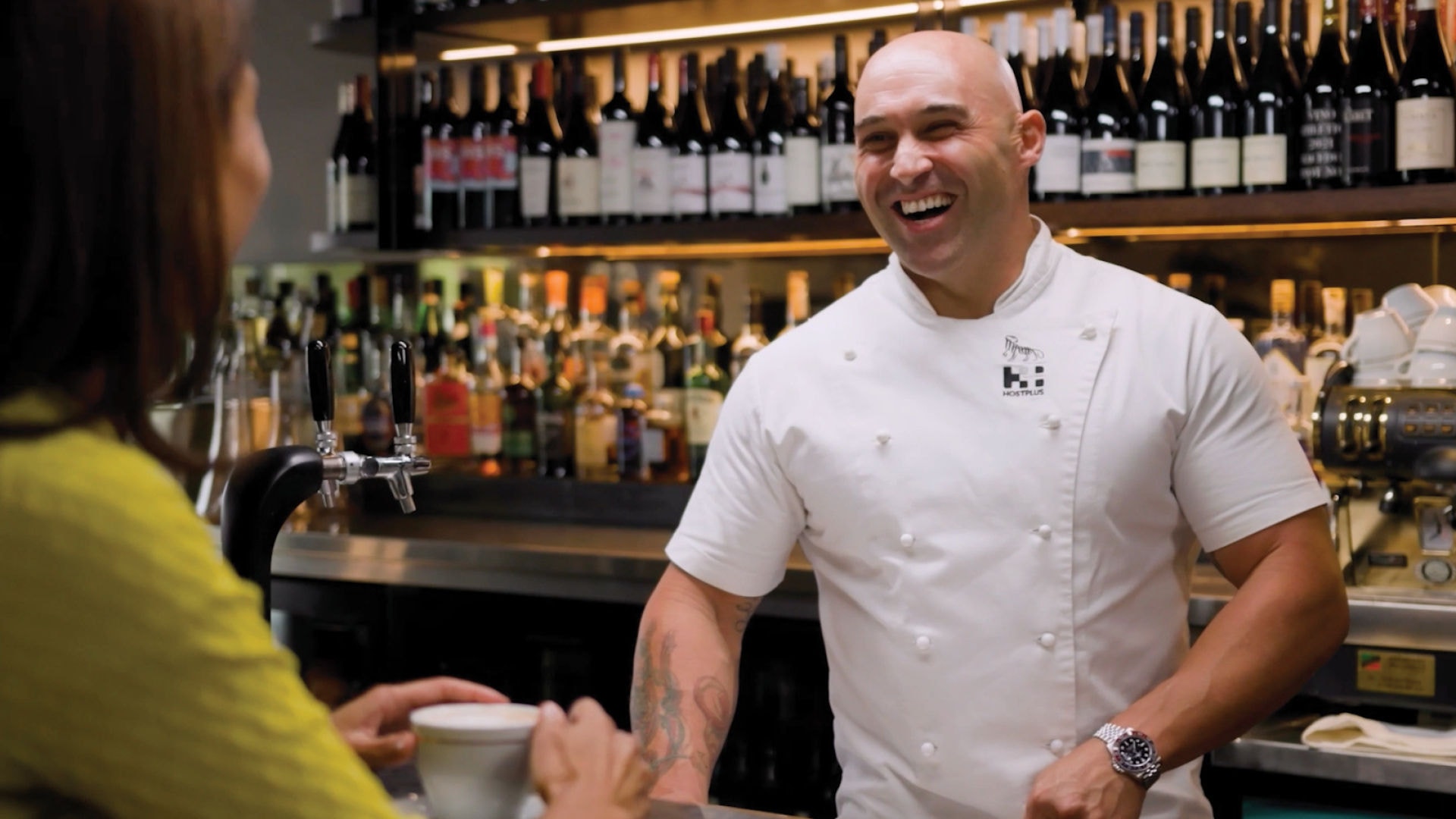 Shane Delia serving a customer in his restaurant