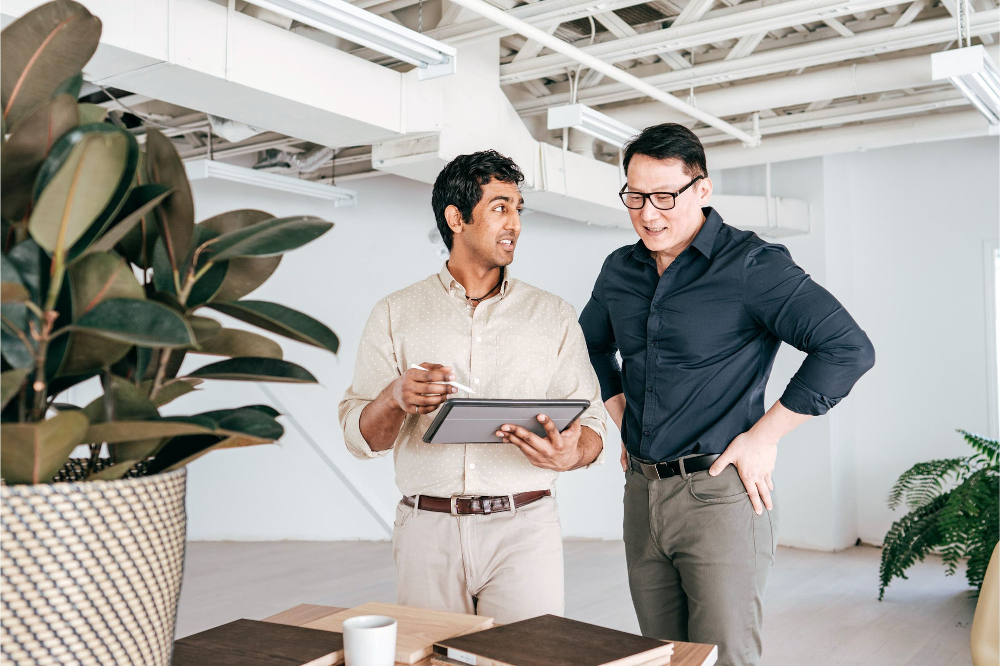 canva-diverse-male-colleagues-office-standing-discussing