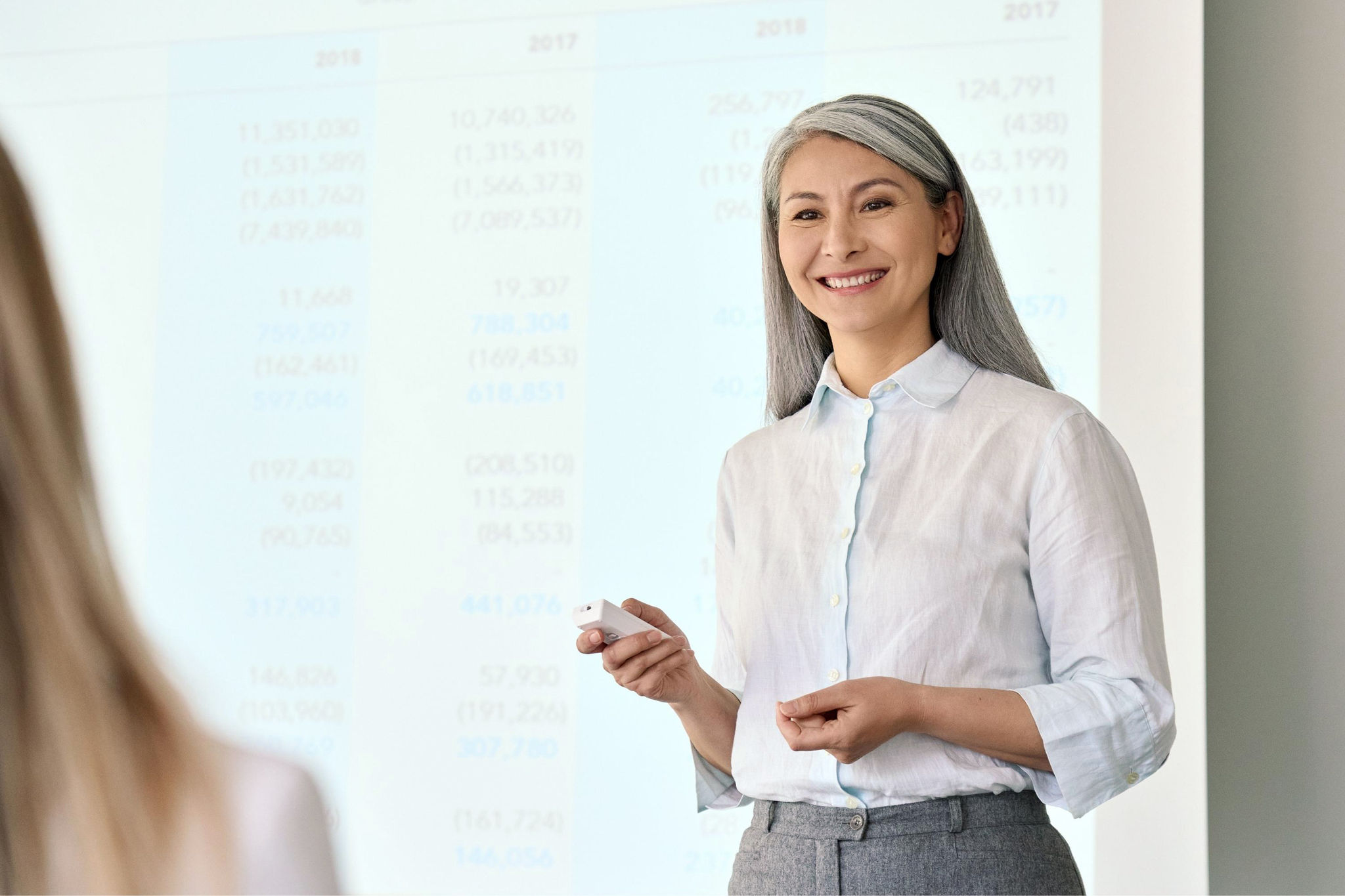 Businesswoman presenting in front of a screen