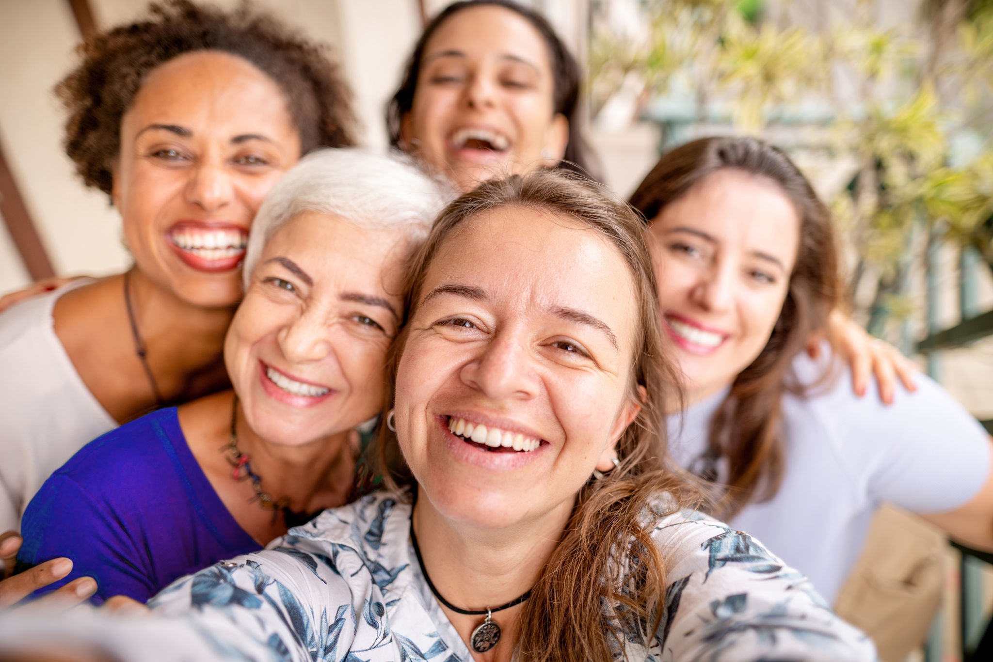 Group of female friends smiling and taking a selfie