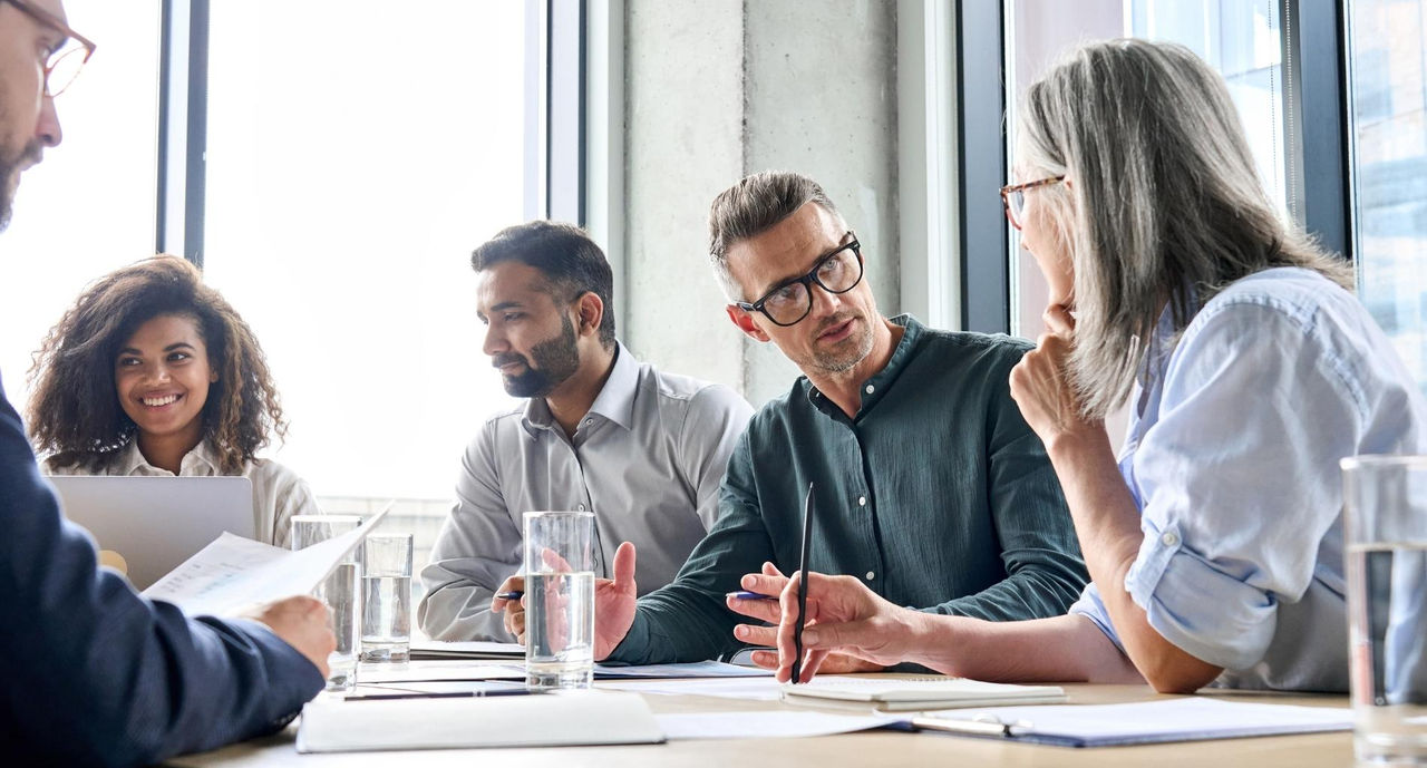 Diverse business colleagues sitting around a board table