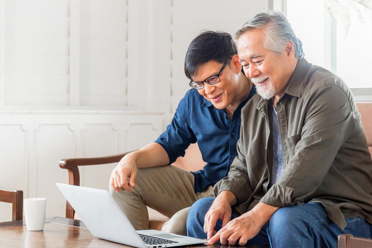 canva-father-son-smiling-laptop