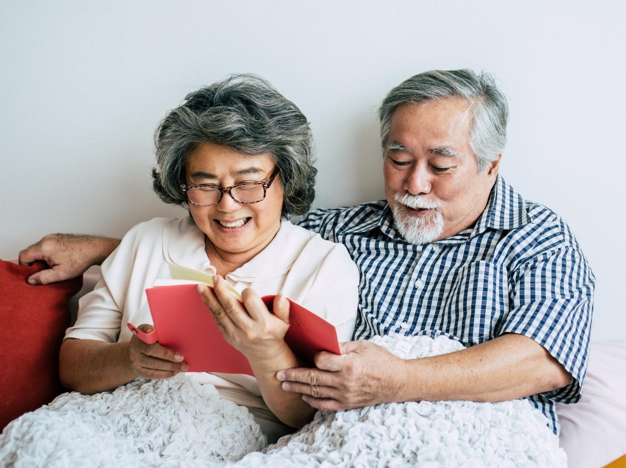 canva-senior-couple-reading-book