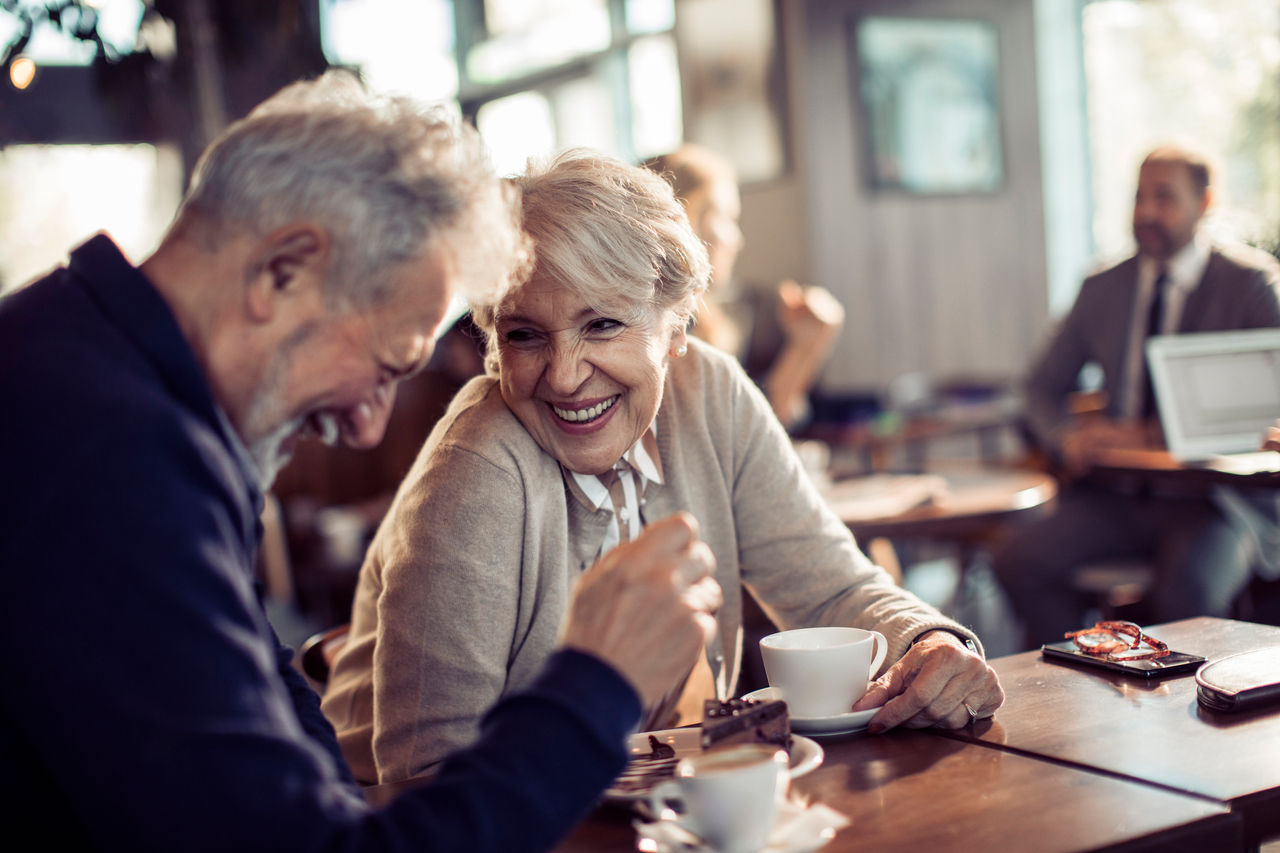 Close up of a happy senior couple having coffee in a cafe